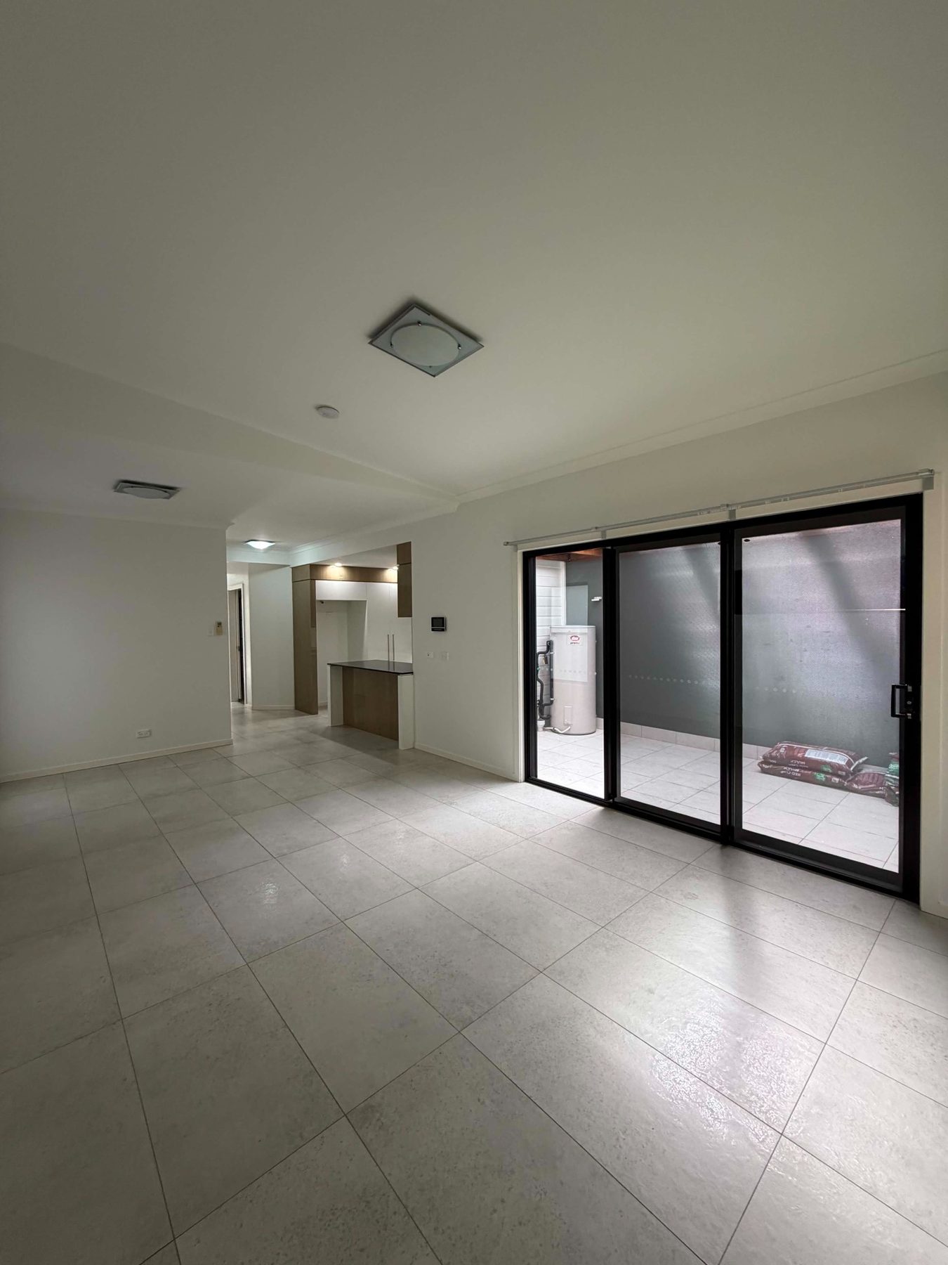 Interior repaint with tiled floor and dark sliding doors